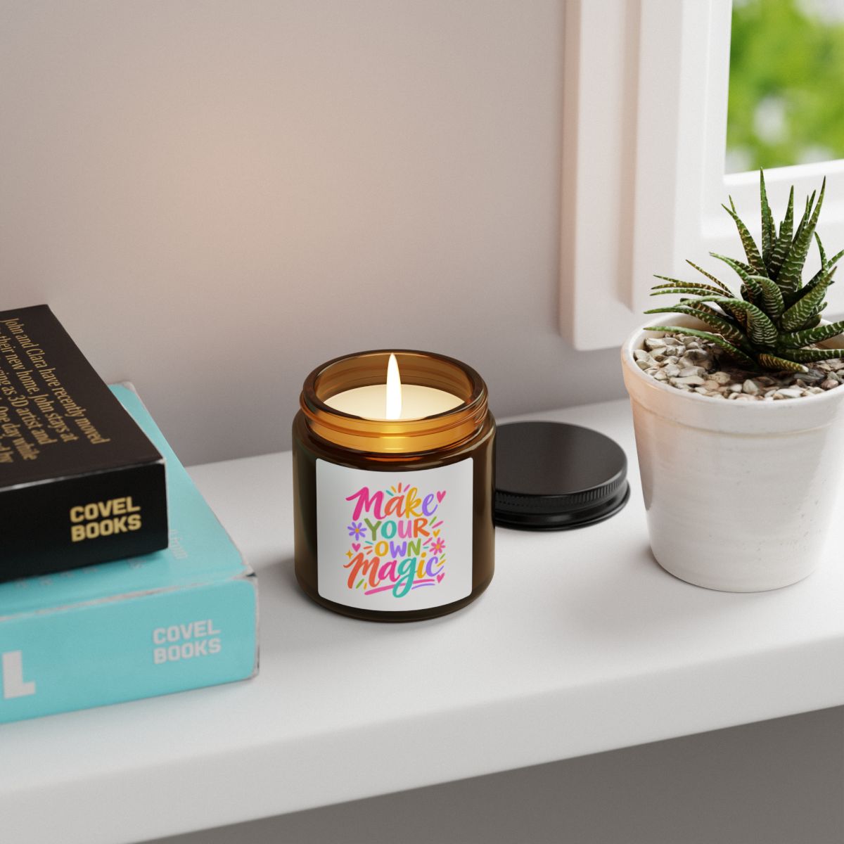 Make Your Own Magic soy candle in an amber glass jar with a bright hand-lettered label, in use