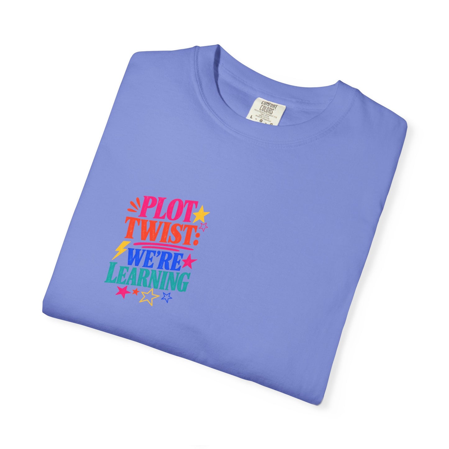 Plot Twist: We're Learning Tee in Flo Blue, folded flat - a small left-chest print on a garment-dyed Comfort Colors 1717 tee.
