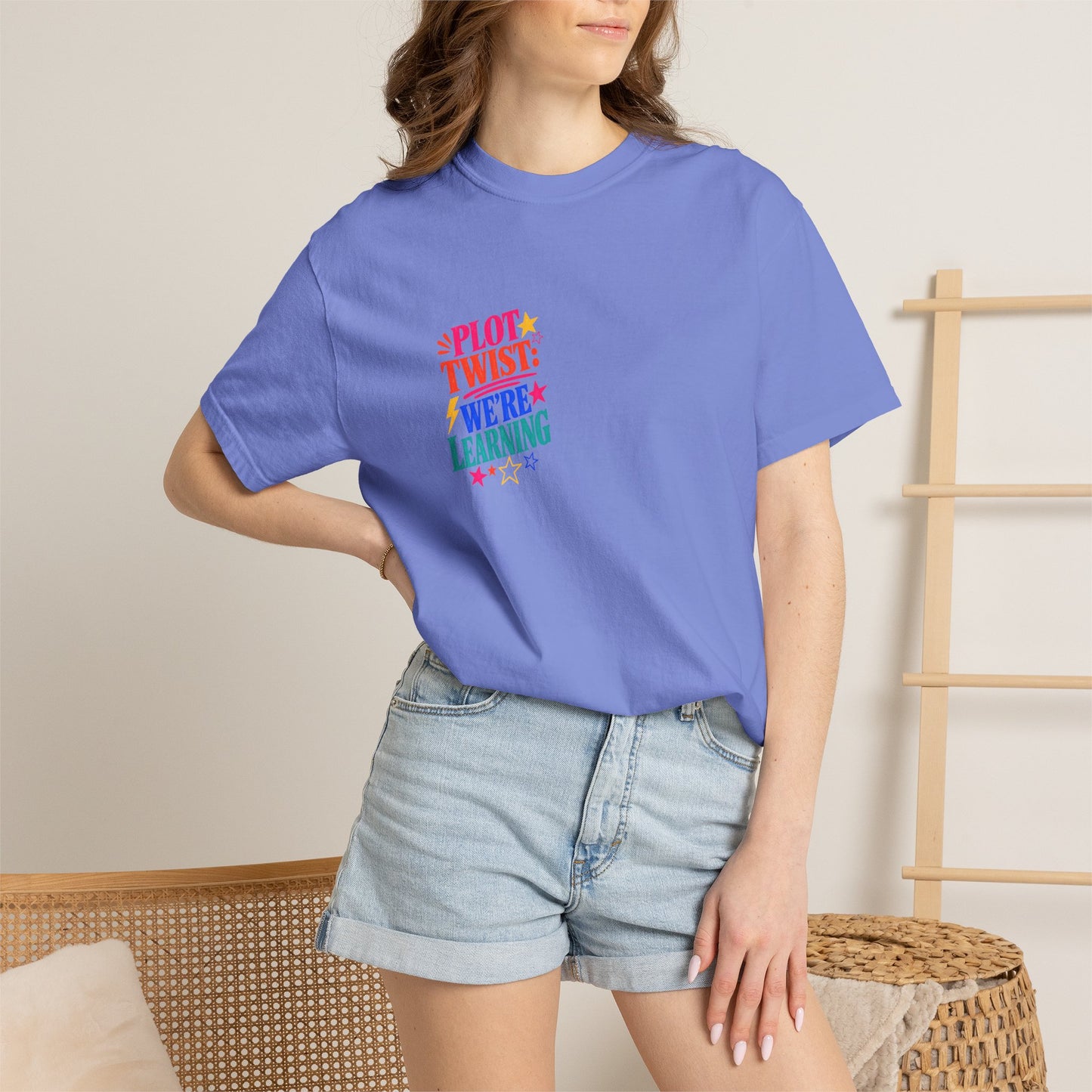 Plot Twist: We're Learning Tee in Flo Blue, worn by a model - a small left-chest print on a garment-dyed Comfort Colors 1717 tee.