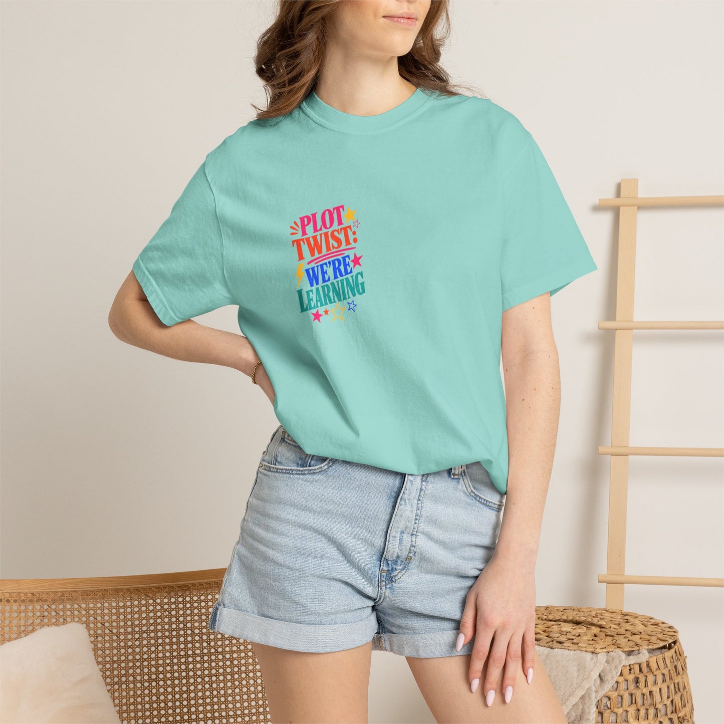 Plot Twist: We're Learning Tee in Chalky Mint, worn by a model - a small left-chest print on a garment-dyed Comfort Colors 1717 tee.