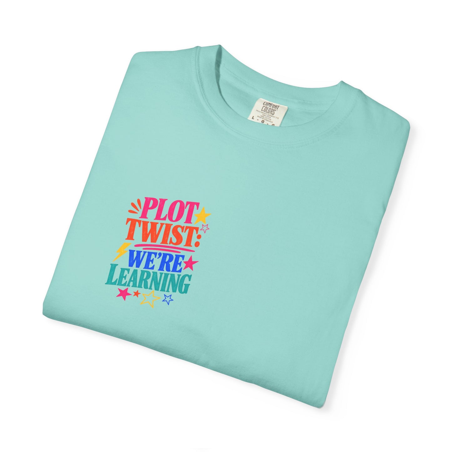 Plot Twist: We're Learning Tee in Chalky Mint, folded flat - a small left-chest print on a garment-dyed Comfort Colors 1717 tee.