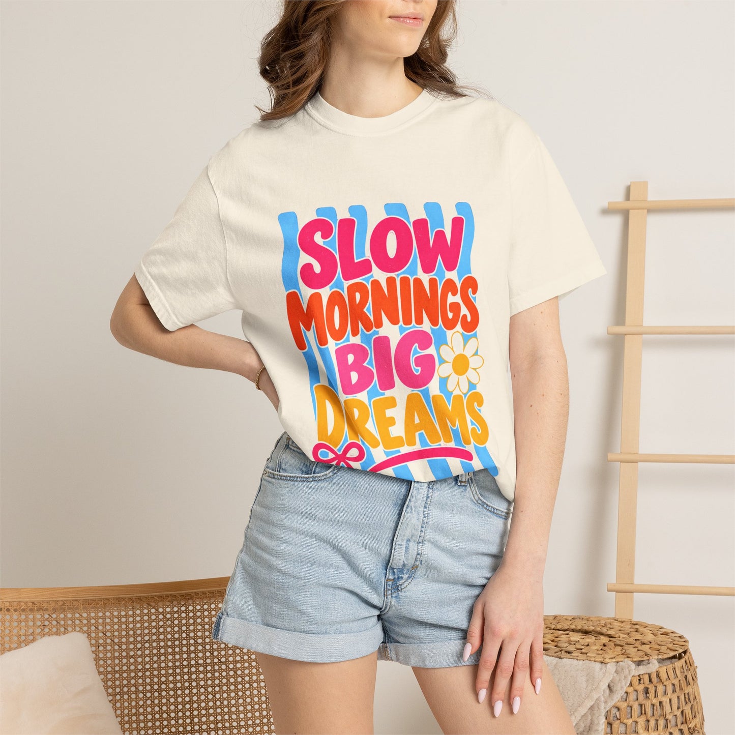 Slow Mornings, Big Dreams Tee in Butter, front view - a large centered full-front print in bold lettering over a wavy stripe backing, on a garment-dyed Comfort Colors 1717 tee.