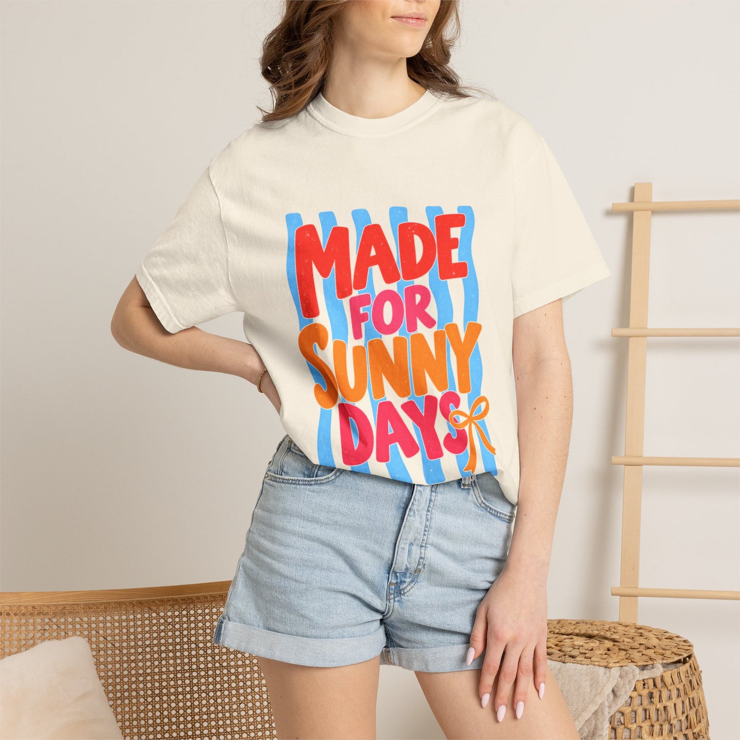 Made for Sunny Days Tee in Butter, front view - a large centered full-front print in chunky red and orange lettering over a wavy stripe backing, on a garment-dyed Comfort Colors 1717 tee.