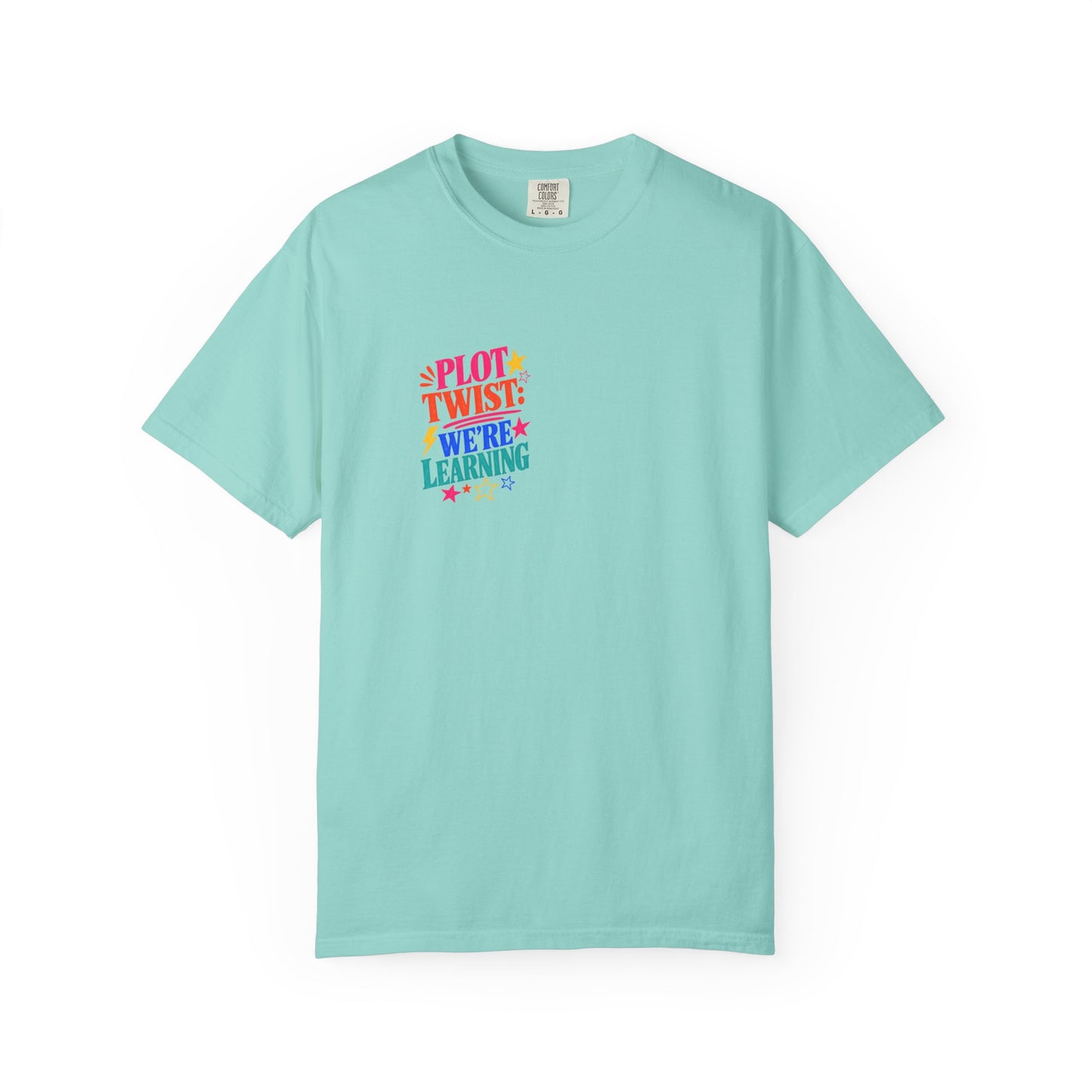 Plot Twist: We're Learning Tee in Chalky Mint, front view - a small left-chest print on a garment-dyed Comfort Colors 1717 tee.