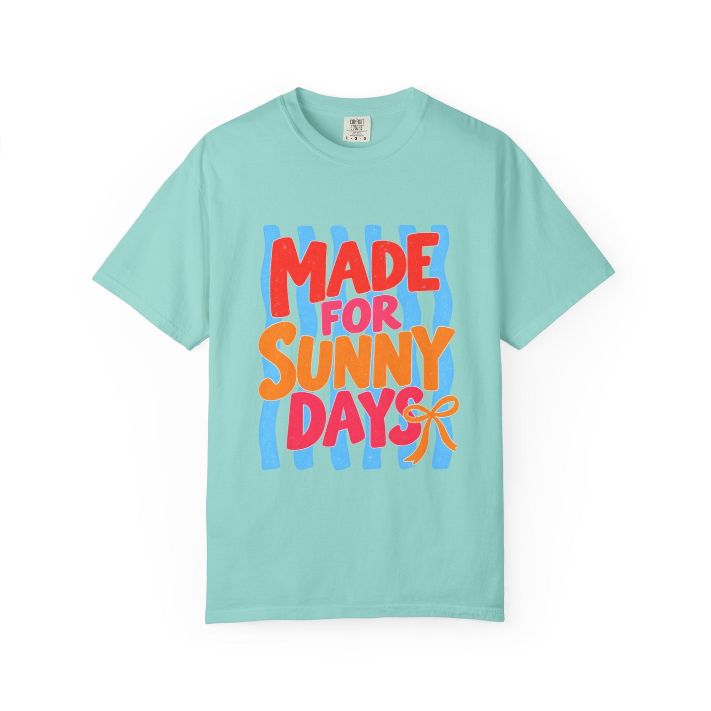 Made for Sunny Days Tee in White, front view - a large centered full-front print in chunky red and orange lettering over a wavy stripe backing, on a garment-dyed Comfort Colors 1717 tee.