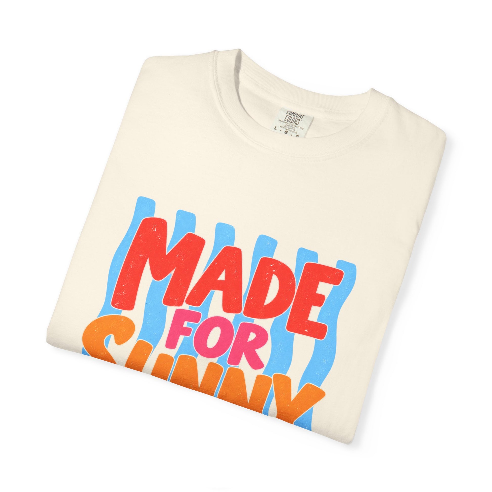 Made for Sunny Days Tee in Butter, front view - a large centered full-front print in chunky red and orange lettering over a wavy stripe backing, on a garment-dyed Comfort Colors 1717 tee.