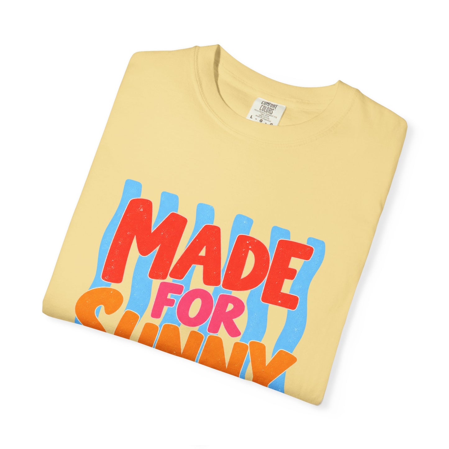 Made for Sunny Days Tee in Butter, front view - a large centered full-front print in chunky red and orange lettering over a wavy stripe backing, on a garment-dyed Comfort Colors 1717 tee.
