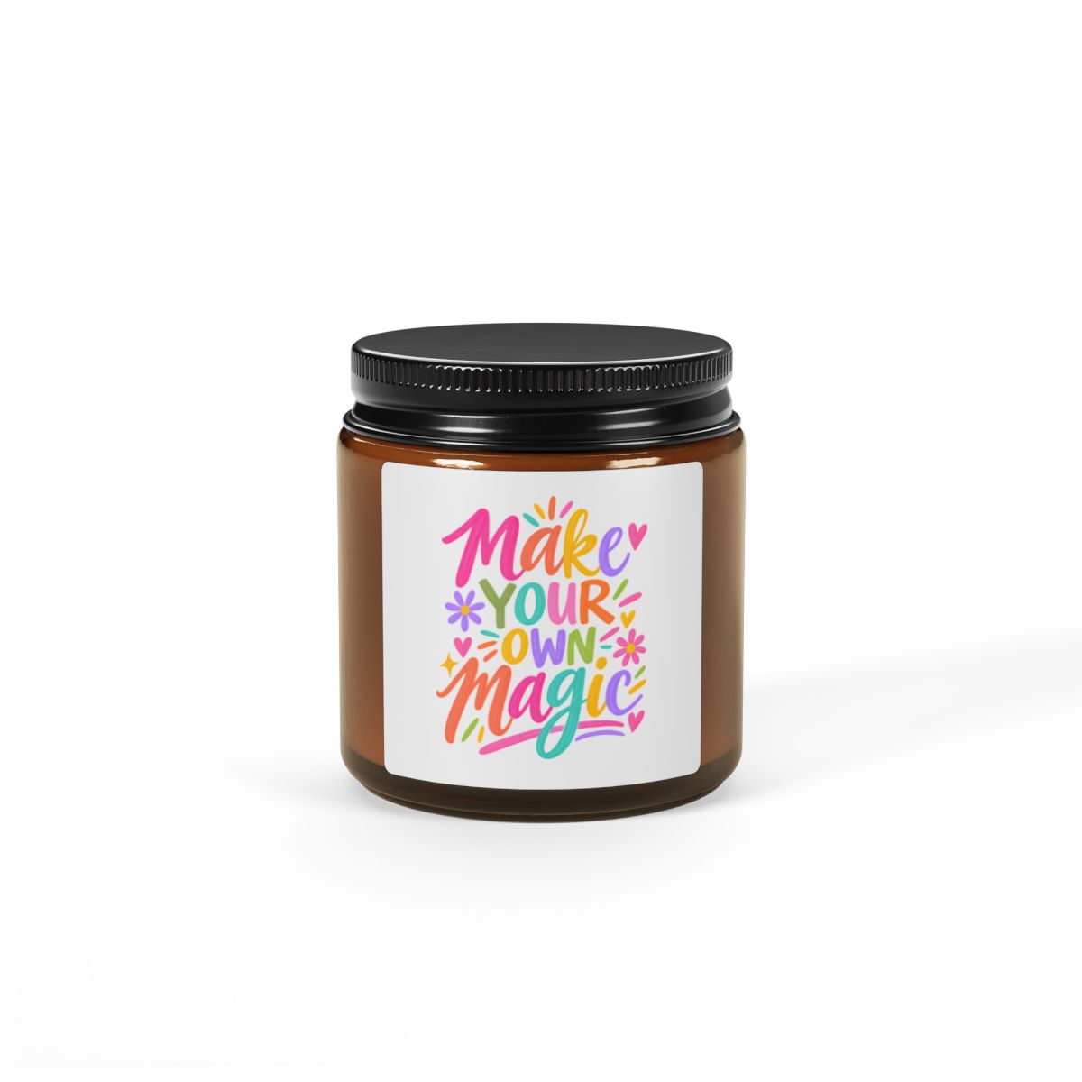 Make Your Own Magic soy candle in an amber glass jar with a bright hand-lettered label, in use