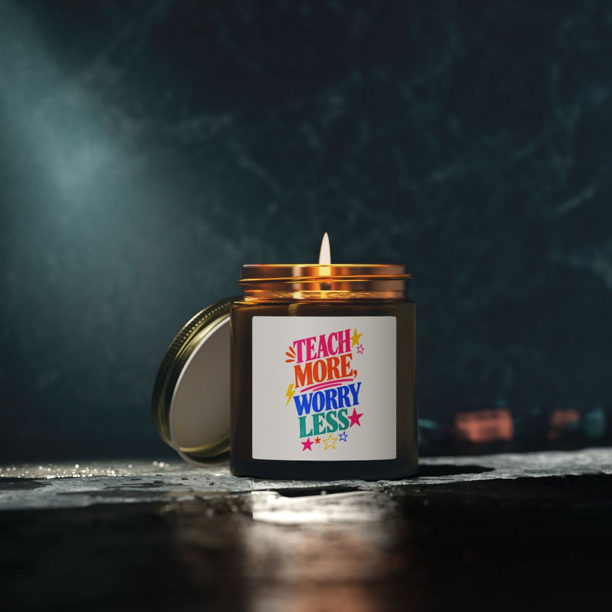 Teach More, Worry Less scented candle in an amber glass jar, in use