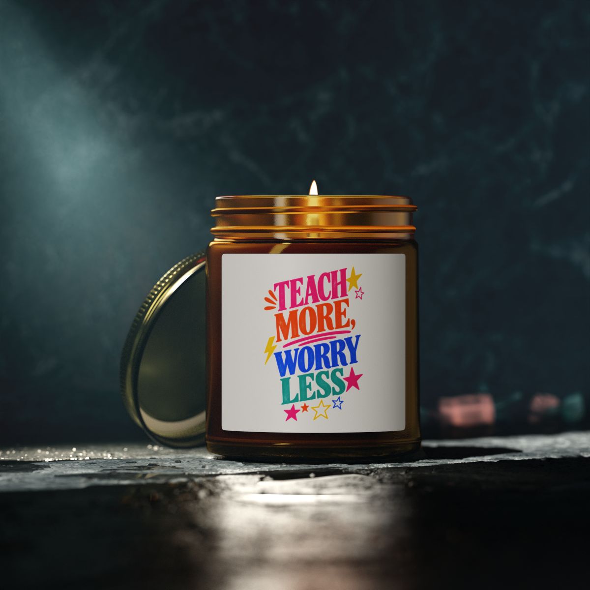 Teach More, Worry Less scented candle in an amber glass jar, in use